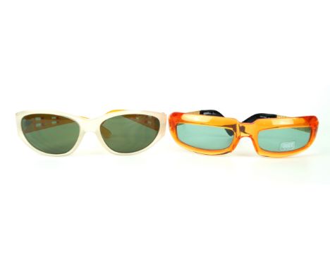Versus by Gianni Versace: Two pairs of vintage sunglasses
Differing designs, the first in a transparent orange, with Versus g