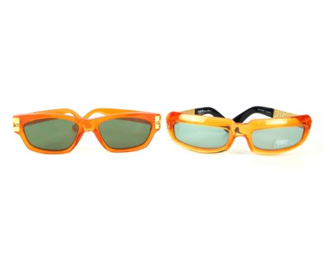 Versus by Gianni Versace: Two pairs of vintage sunglasses
Differing designs, both in a transparent orange, the first with wit
