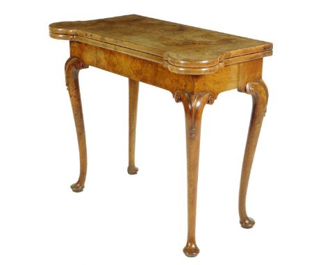 A walnut card table, the swivel and hinged burr veneered top with cross and feather banding revealing a baize lined surface, 