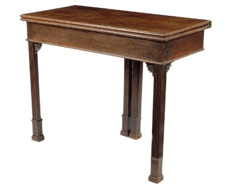 A George III mahogany card table, the fold-over top on unusual gate supports on fluted legs with leaf carved and beaded brack