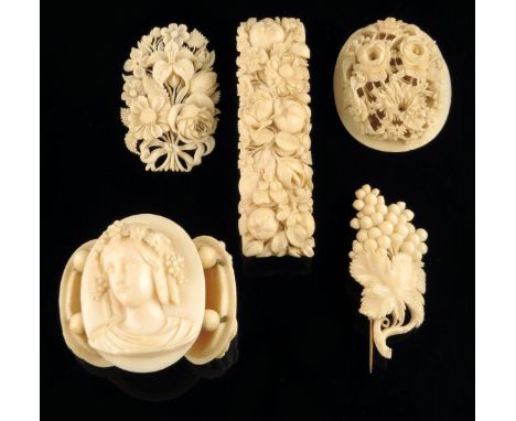 λ Three carved ivory portrait cameos, of classical ladies, three carved ivory floral brooches and a carved ivory basket of fl