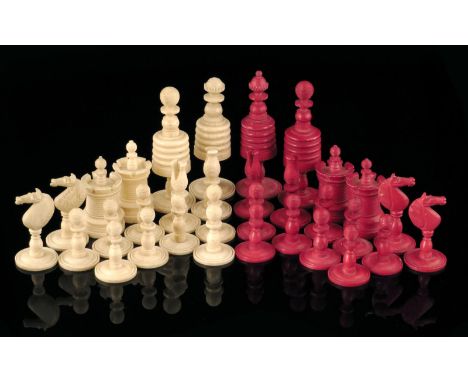 A 19th century turned bone chess set, natural and stained red, the king: 8.5cm high, the pawn: 3.4cm. (32)