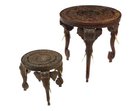 λ An Indian rosewood occasional table, the circular top carved with bands of scrolling foliage and with a central rondel with