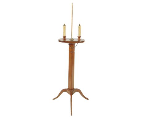 A French cherrywood twin light standard lamp, with an adjustable stem on tripod supports, 113.5cm high, 43cm wide.