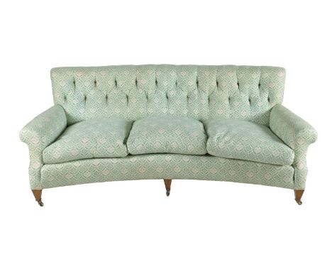 A Lenygon & Morant 'Howard' three seater sofa, with a button back and a concave front, with loose covers and 'H & S' monogram