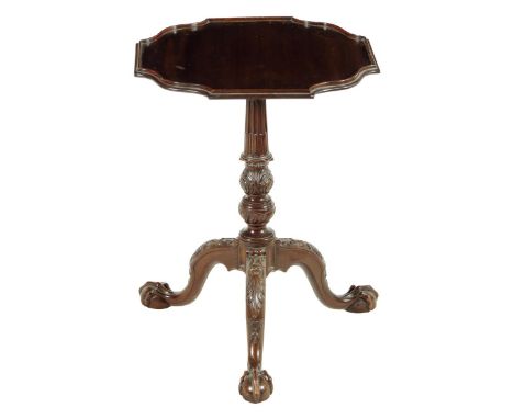 A mahogany tripod table in George III style, with a fixed top above a carved base on claw and ball feet, late 19th / early 20