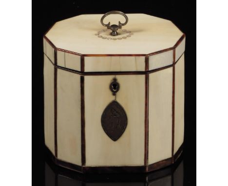 λ A George III ivory decagonal tea caddy, inlaid with tortoiseshell stringing, the front with a navette shape escutcheon engr