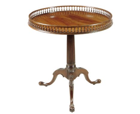 An early George III mahogany tripod table, the circular tilt-top with a balustraded gallery, above a fluted stem and leaf and