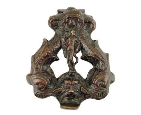 An Italian bronze door knocker, the centre with a hunter with his bow and quiver of arrows flanked by a pair of dolphins abov