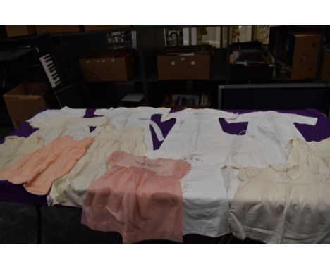 A mixed lot of vintage and antique babies clothing.
