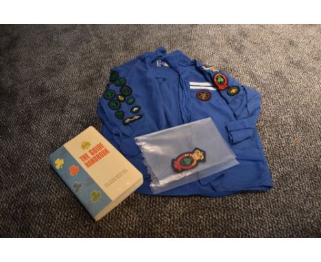 A 1960s girl guides blouse with a collection of badges, book and spare badge.