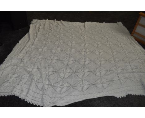 An antique white knitted bed spread,approx 108' X 70'.