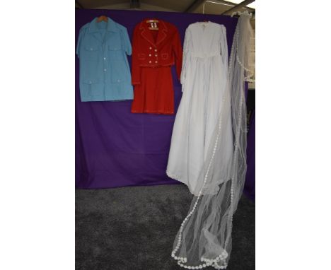 A mixture of ladies vintage clothing including wedding dress.