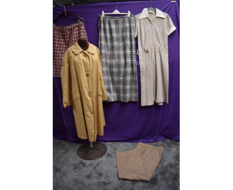 A collection of ladies vintage clothing including rain mac and wool skirt.
