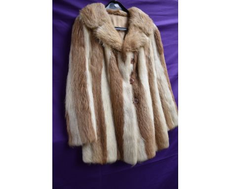 A ladies vintage fur coat having contrasting panels.