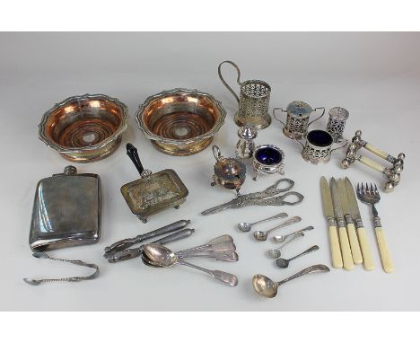 A pair of silver plated bottle coasters, a hip flask, cruet sets, knife rests, grape scissors and other items