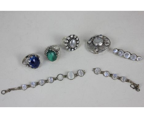 A moonstone brooch in silver, a similar ring, a bar brooch and bracelet, a turquoise ring, and a blue stone ring