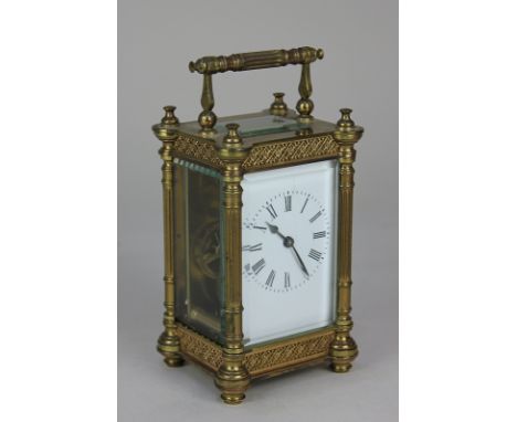 A brass carriage clock, the case with fluted pillars, lattice and floral borders, the enamelled dial with Roman numerals, 13c