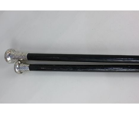 A George V silver mounted ebonised walking stick, makers Henry Tracy &amp; Sons, London 1926, together with another silver mo