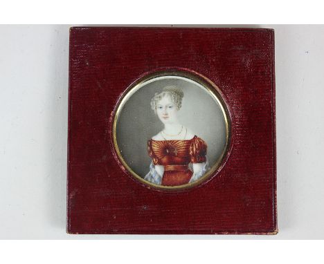 A 19th century miniature portrait of a young lady with blue eyes and pale hair in ringlets, wearing a gold cross and red gown
