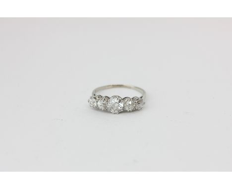 A diamond five-stone ring claw set with graduated old cuts in platinum