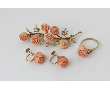 An 18ct gold and carved coral floral spray brooch, a matching ring, and a pair of screw fitted matching earrings