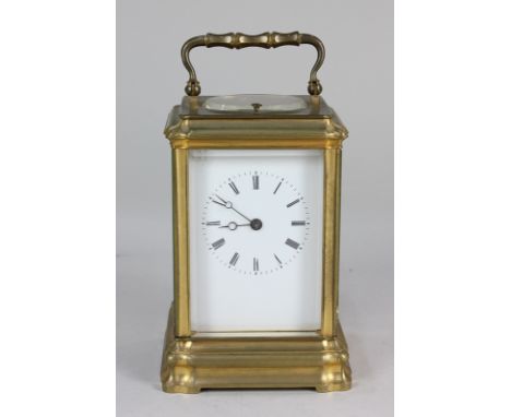 A French brass repeater carriage clock with white enamel dial and Roman numerals, movement striking on a bell, 16cm