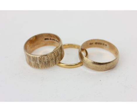 A 22ct gold wedding ring, 2.9g, two 9ct gold rings, 8.7g