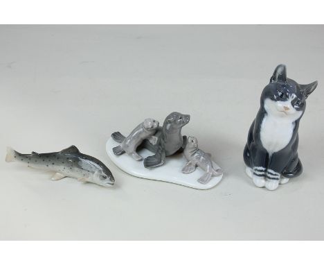 Two Royal Copenhagen porcelain models of a black and white cat, 14cm, and a fish, 11.5cm long, together with a Lladro porcela