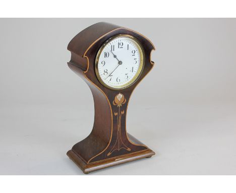 An Art Nouveau mahogany inlaid mantel clock, the waisted case decorated in satinwood and mother of pearl with a sinuous plant