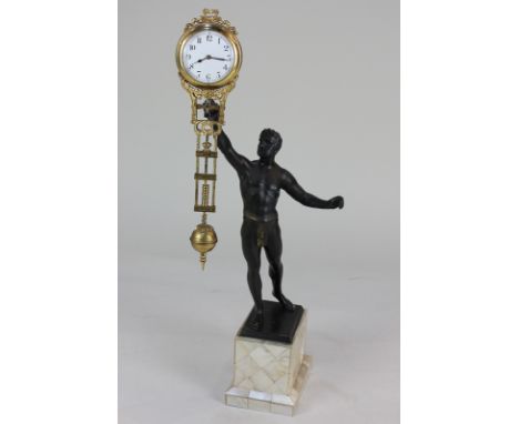 A late 19th / early 20th century pendulum timepiece in the form of a bronzed figure of an athlete holding aloft the swing tim