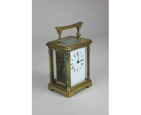 A  brass cased carriage clock, the white enamel dial with Roman numerals, the movement stamped 'France', 11cm, with key