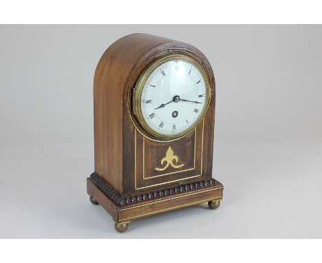 A late 19th century mahogany and brass inlaid mantel clock, the case of domed form, the circular enamel dial with Roman  nume