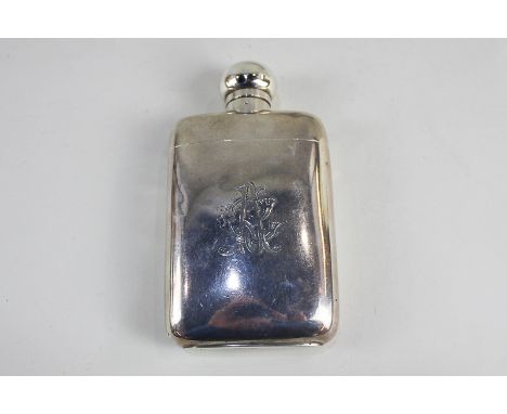 An Edward VII silver hip flask with detachable stirrup cup, maker Elkington &amp; Co, London 1901, 8.5oz gross, monogrammed