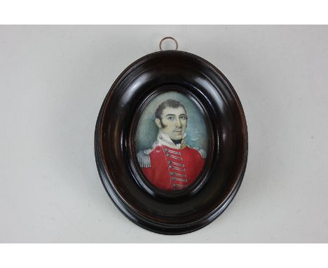 A 19th century miniature portrait on ivory of an officer dressed in red tunic, partial inscribed paper label verso, 6.8cm by 