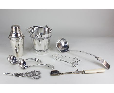 A Harrods silver plated cocktail shaker, an ice bucket, a pair of sauce ladles, a soup ladle, a cheese scoop, a pair of grape