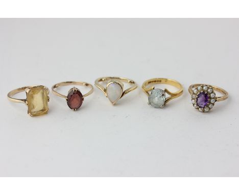 An amethyst and pearl ring, an aquamarine ring, a citrine ring, a garnet ring, and an opal ring