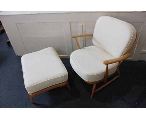 A light Ercol armchair with matching stool