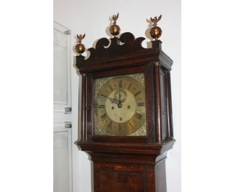 A George II oak longcase clock by John Buffett, Colchester, the 12 inch brass dial with scrolling mask spandrels, secondary d