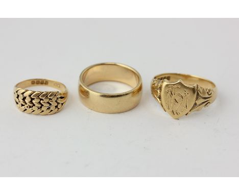 An 18ct gold signet ring, two other 18ct gold rings, 23.7g