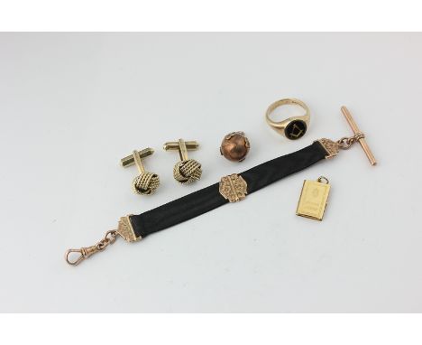 A 9ct gold and black onyx Masonic ring, a gold Masonic ball charm on silk fob, a pair of knot cufflinks, and a novelty pendan