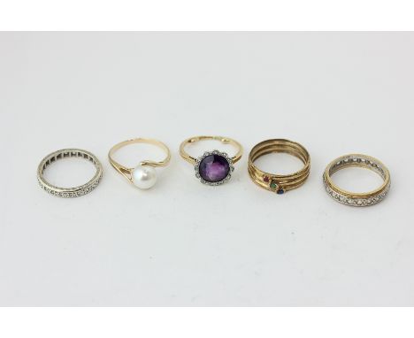 An amethyst and rose diamond ring, a pearl ring, two white sapphire full hoop rings, and a three-stone ring