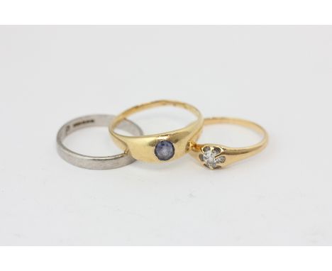 An old cut diamond single stone ring, a platinum wedding ring, and a sapphire ring