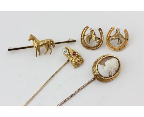 A 14ct gold, pearl and ruby eagle head stick pin, a shell cameo stick pin, a pair of horse head and shoe ear studs, and a hor