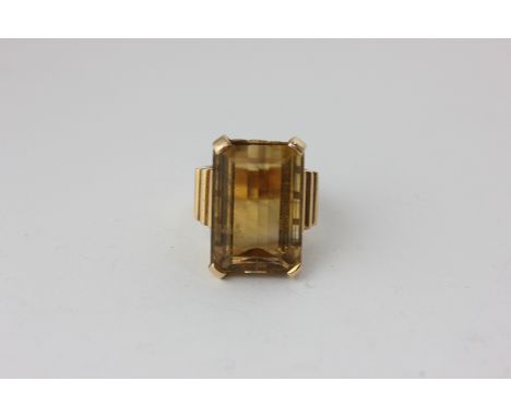A citrine dress ring, claw set on a wide flat shank