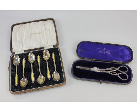 A pair of Victorian silver grape scissors, maker Gilbert and Spurrier, Birmingham 1886, and a cased set of George V silver gi