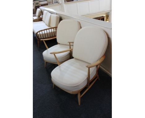 A pair of light Ercol stick-back armchairs