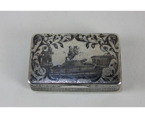 A Russian 84 Zolotniks silver snuff box, the niello design of a figure on rearing horseback, and boat in harbour, 8cm wide