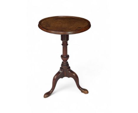 A George III mahogany kettle stand
The circular moulded top above a ring turned shaft on cabriole legs and pad feet, 37cm dia