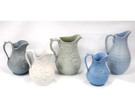 Three Dudson Pottery 'Vine Leaf' pattern moulded stoneware jugs, the largest 19cm high, and two others, 'Poppy' and foliate, 